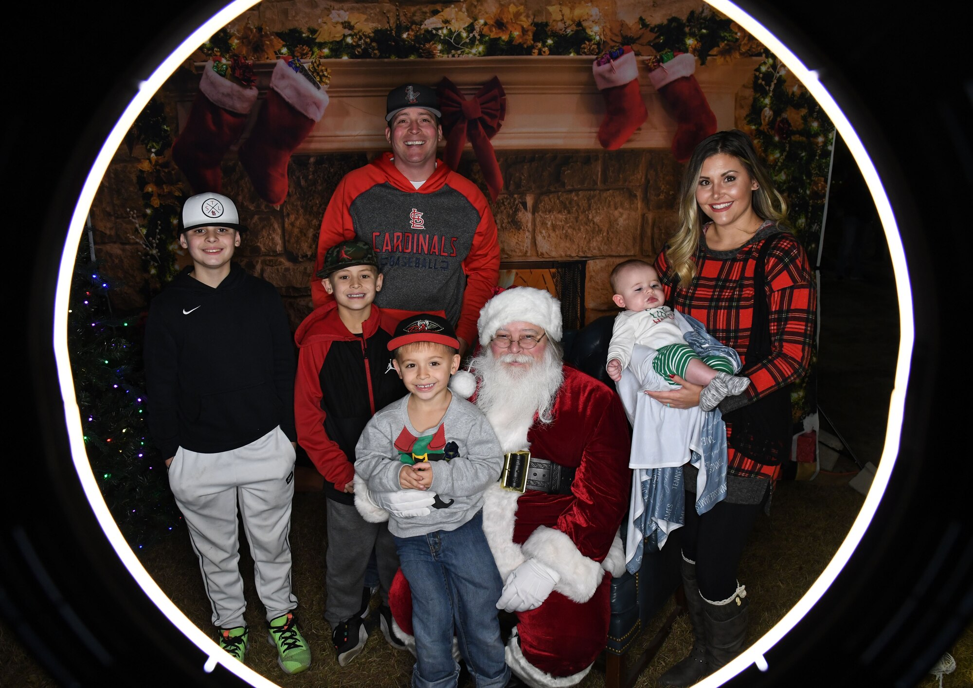 U.S. Air Force Tech. Sgt. Derek Padgett, 334th Training Squadron instructor, and his family pose for a photo with Santa during Holiday in the Park at Keesler Air Force Base, Mississippi, Dec. 1, 2022.