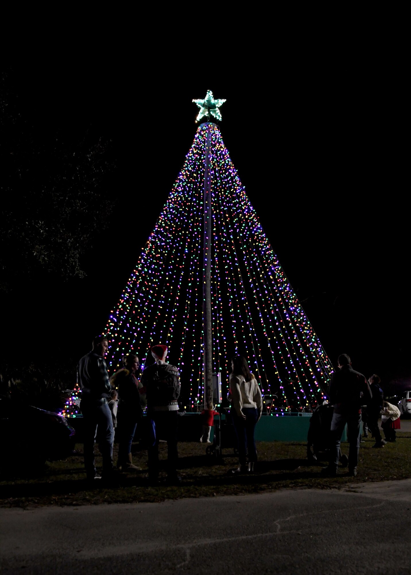 Military families gather around the Christmas tree during Holiday in the Park at Keesler Air Force Base, Mississippi, Dec. 1, 2022.