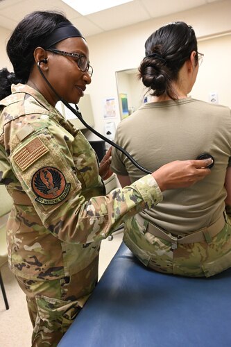 Maj. (Dr.) Emem Idem listens to an Airman's breathing during a recent unit training assembly at Tinker Air Force Base, Oklahoma.