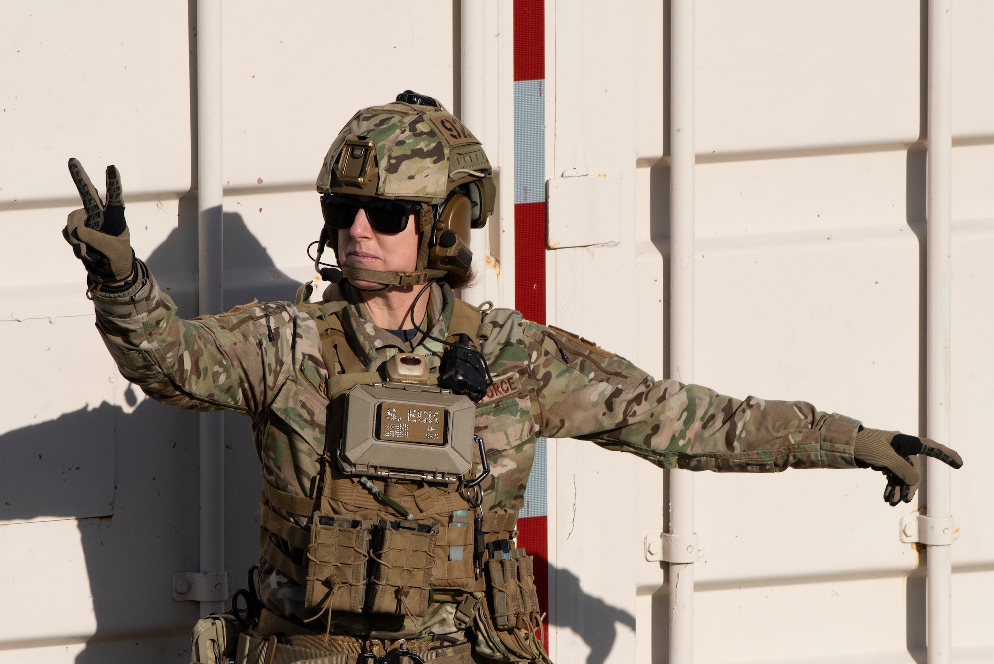 Airman signals to other Airmen.