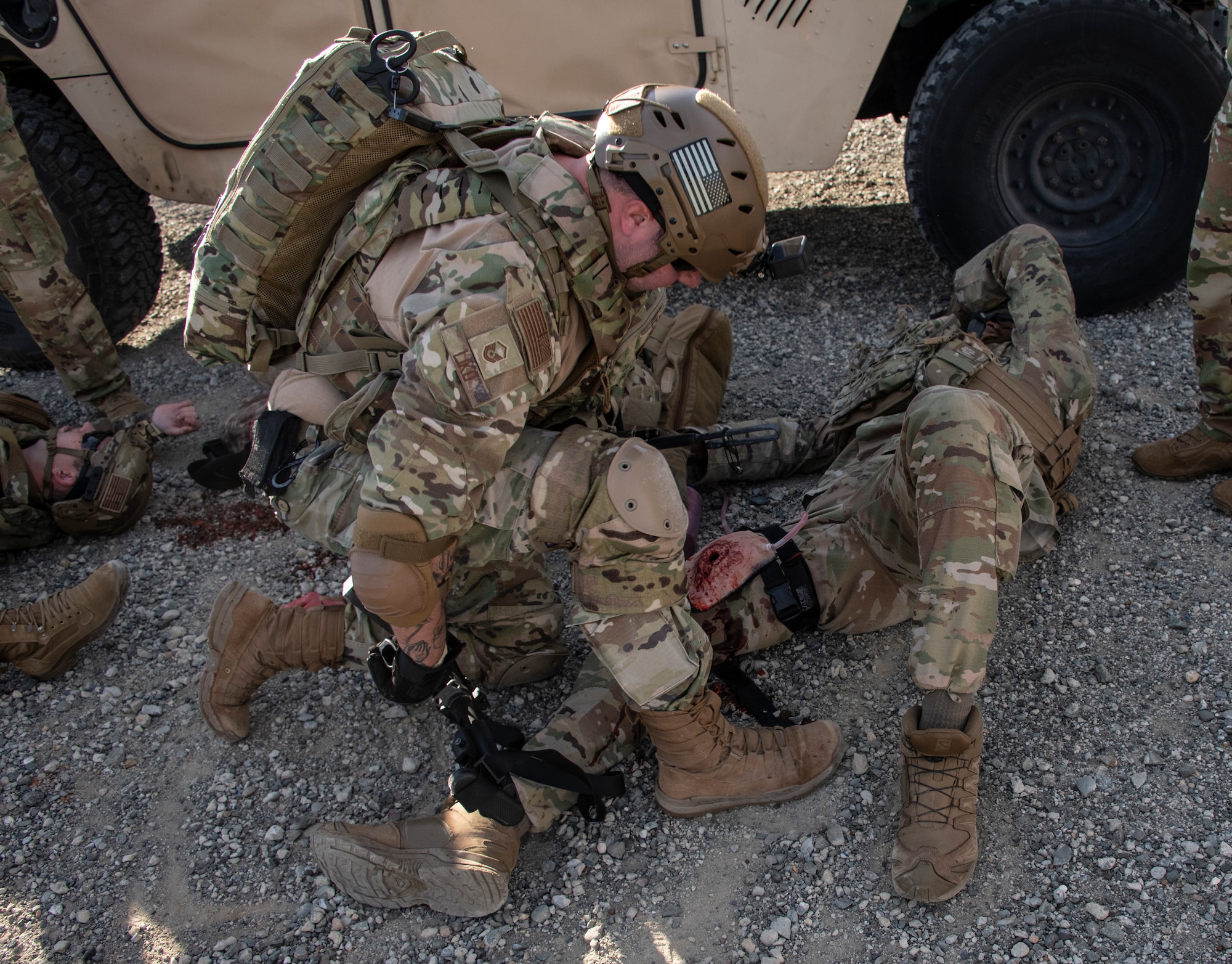 Airman attends to another airman.