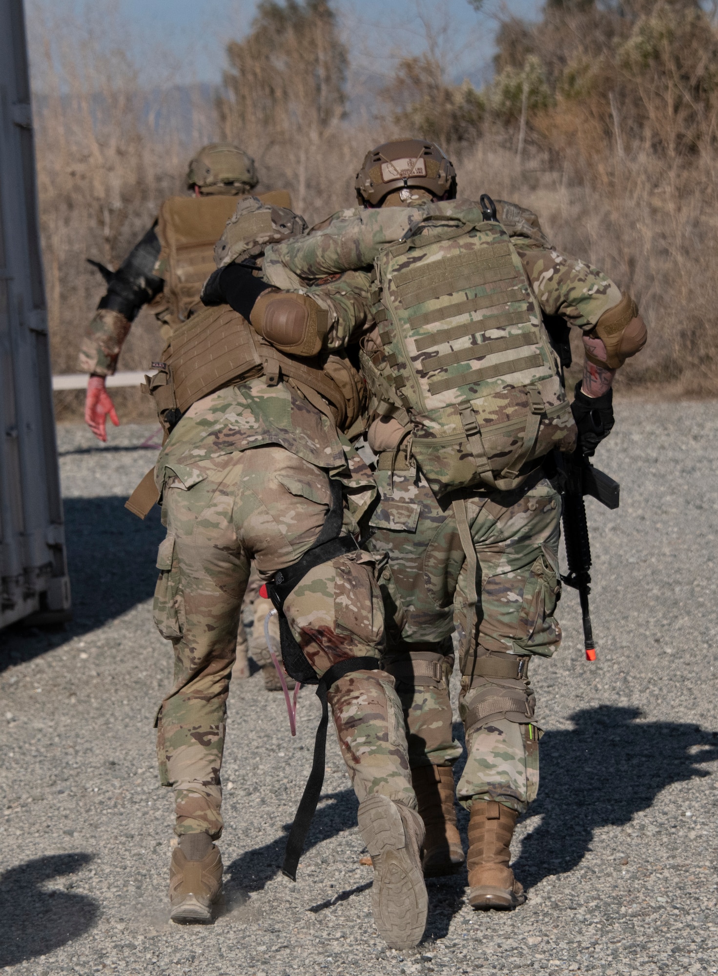 Airman leans on another Airman.