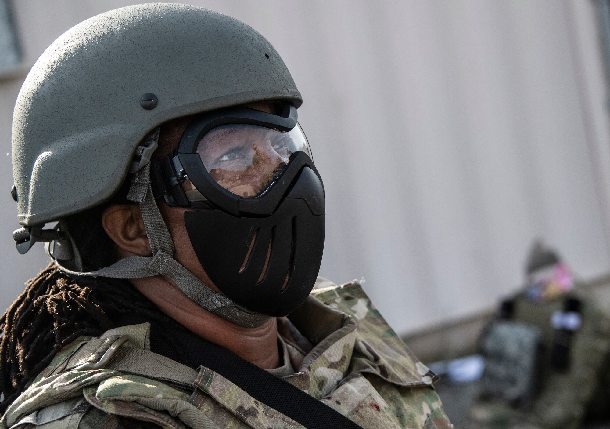 Airman wears a combat helmet.