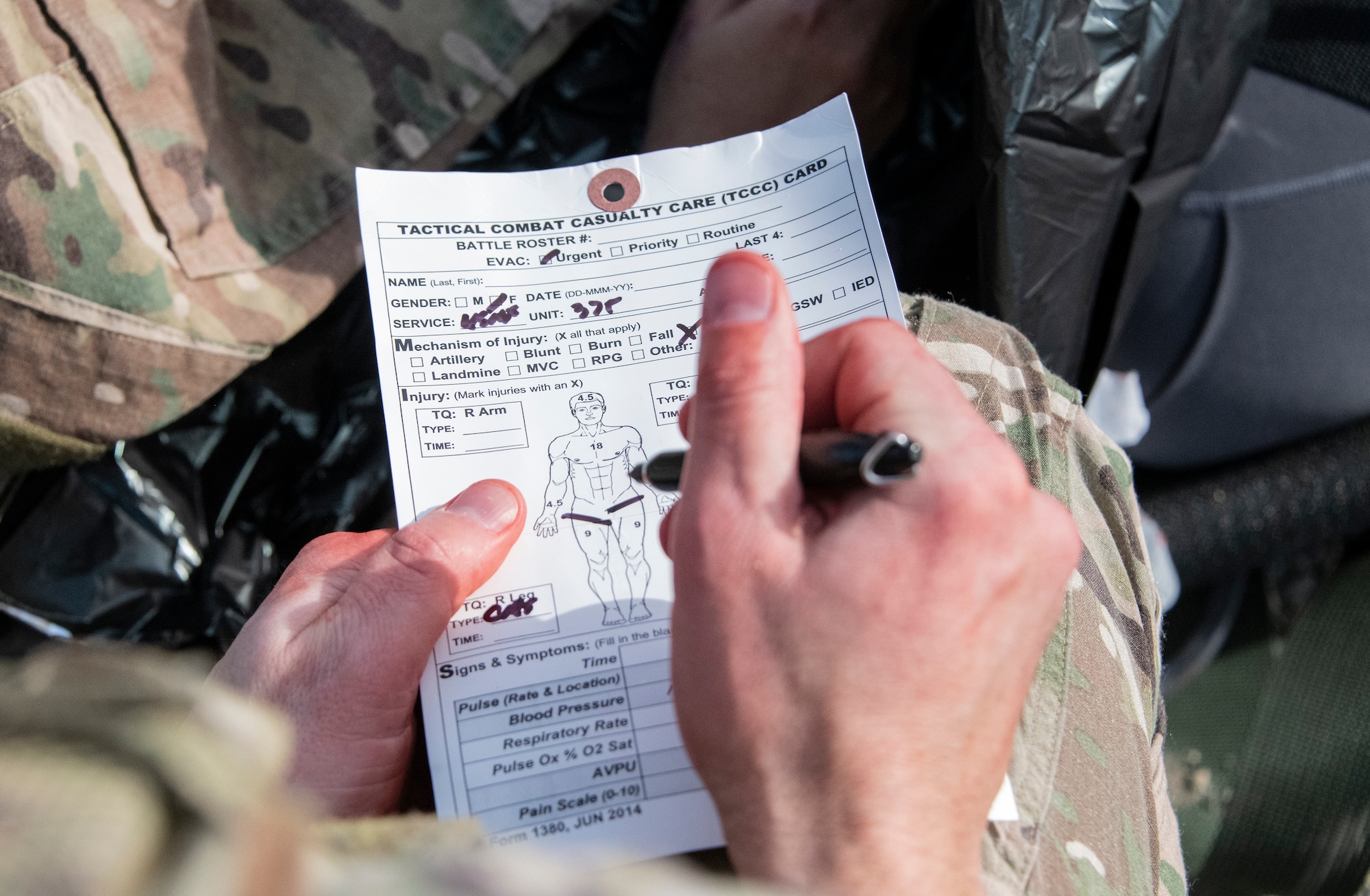 Airman make notes on a medical form.