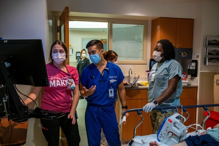 Tech. Sgt. Erika Williams, 932nd Medical Squadron medical technician, works with a civilian patient at a Mercy Hospital.