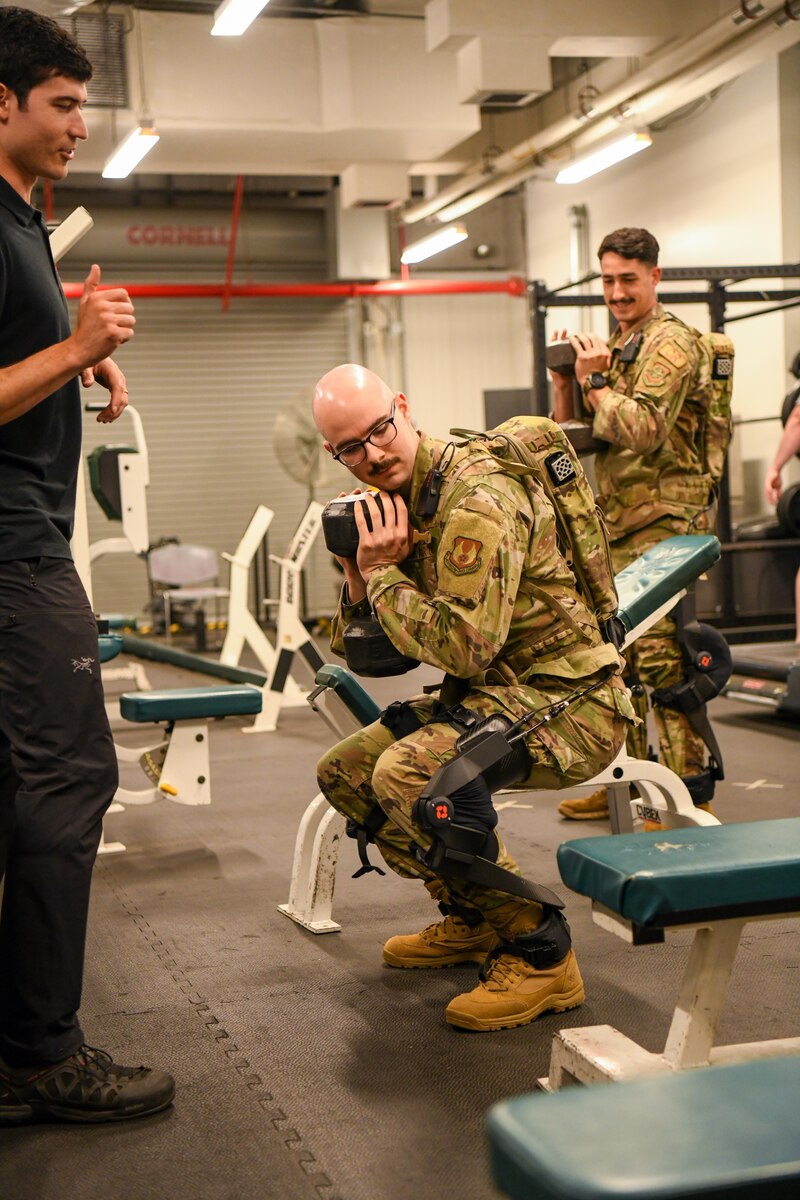 Second Lt. Ian Casciola, 711th Human Performance Wing special warfare electrical engineer, performs a squat while wearing a pneumatically-powered exoskeleton system during an Air Force Research Laboratory demonstration at Wright-Patterson Air Force Base, Ohio, Oct. 6, 2022. The exoskeleton was designed to assist aerial porters load and unload heavy cargo and is intended to minimize manpower and prevent injuries. (U.S. Air Force photo by Patrick O’Reilly)