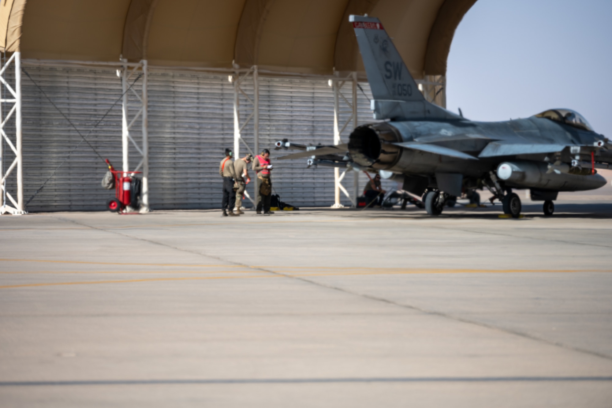 A group of aircraft maintainers assigned to the 77th Expeditionary Fighter Generation Squadron, prepare to recover an F-16 Fighting Falcon following a sortie launched from Prince Sultan Air Base, Kingdom of Saudi Arabia Nov. 14, 2022.