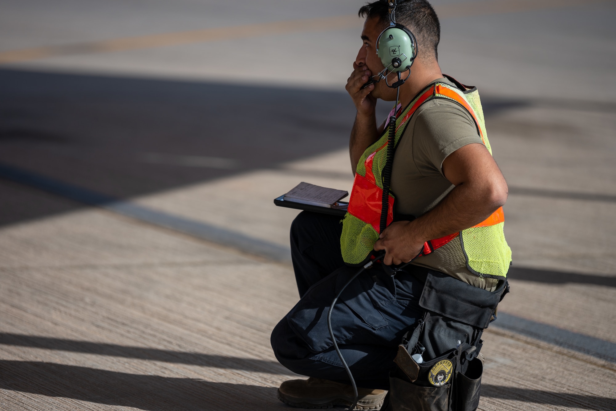 U.S. Air Force Senior Airman Kevin Monzon, a 77th Expeditionary Fighter Generation Squadron weapons load crew member communicates with an F-16 pilot during a pre-flight inspection, at Prince Sultan Air Base, Kingdom of Saudi Arabia.