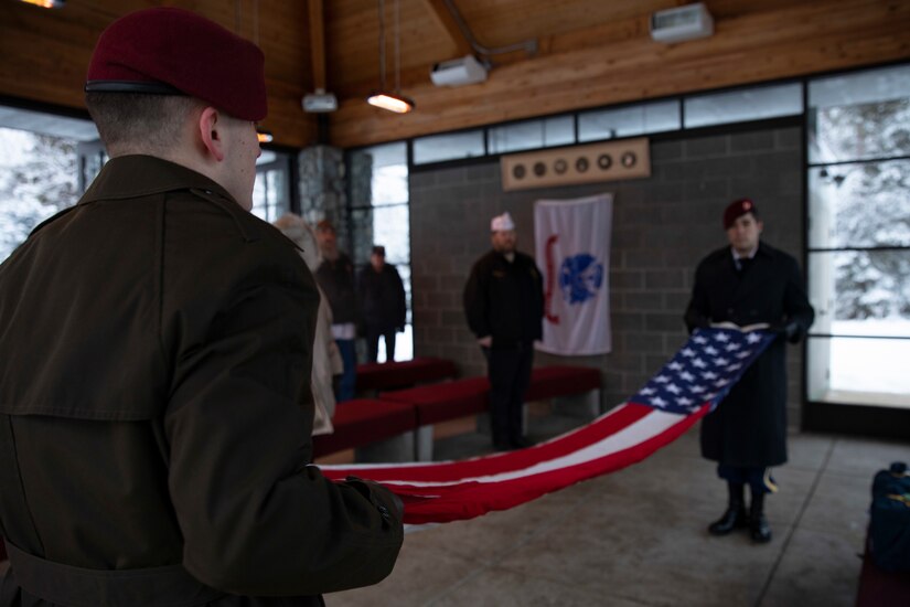 U.S Army honor guard Soldiers unfold an American flag during an unaccompanied funeral service for the remains of five veterans at the Fort Richardson National Cemetery on Joint Base Elmendorf-Richardson, Alaska, Nov. 30, 2022. The Department of Military and Veterans Affairs works jointly with the federally recognized non-profit organization Missing in American Project in locating, identifying and interring the unclaimed cremated remains of veterans with full honors and ceremony. (Alaska National Guard photo by Victoria Granado)
