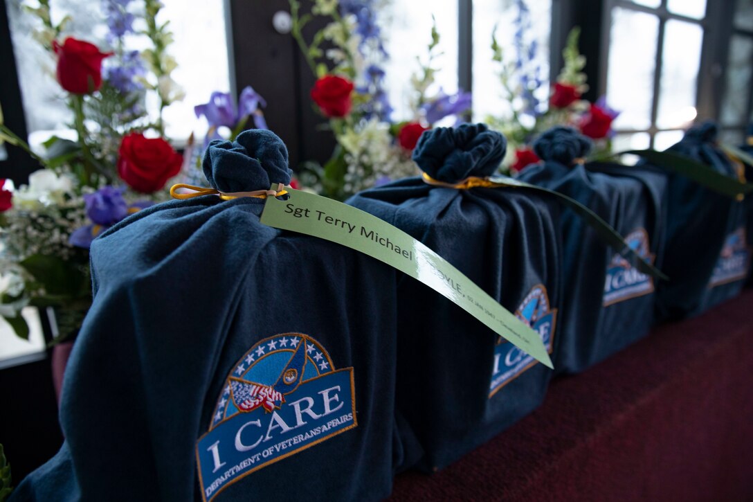 Service members, civilians and veterans pay their final respects to the remains of five veterans during an unaccompanied funeral service at the Fort Richardson National Cemetery on Joint Base Elmendorf-Richardson, Alaska, Nov. 30, 2022. The Department of Military and Veterans Affairs works jointly with the federally recognized non-profit organization Missing in American Project in locating, identifying and interring the unclaimed cremated remains of veterans with full honors and ceremony. (Alaska National Guard photo by Victoria Granado)