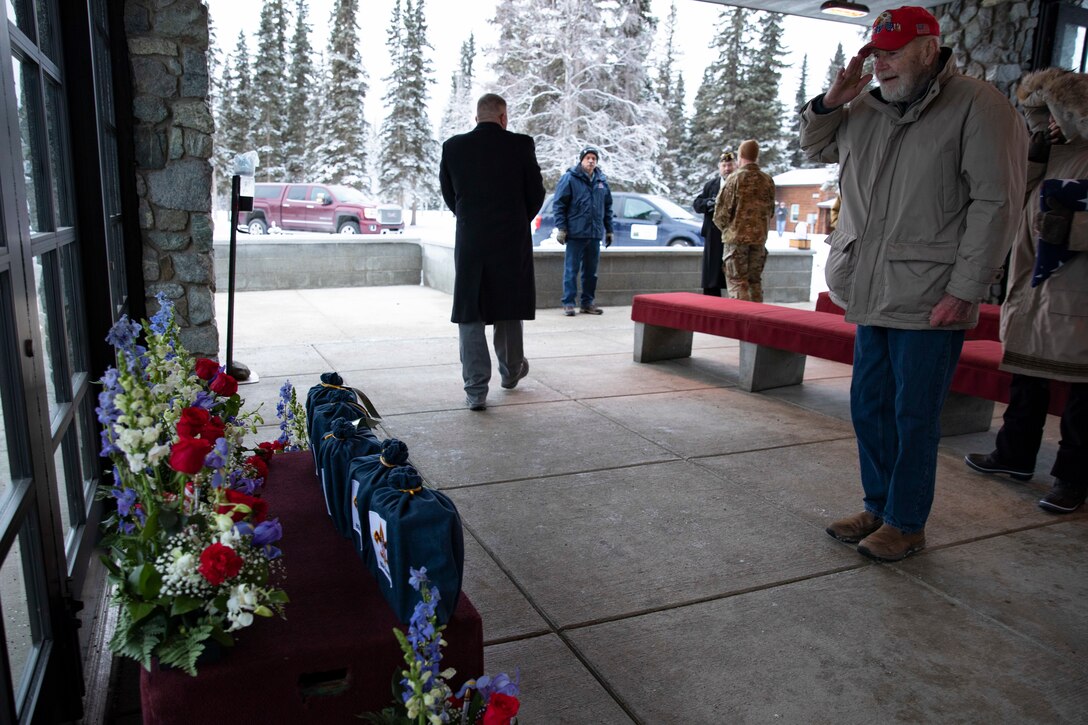 A U.S. Army veteran renders a salute to the remains of five veterans after an unaccompanied funeral service at the Fort Richardson National Cemetery on Joint Base Elmendorf-Richardson, Alaska, Nov. 30, 2022. The Department of Military and Veterans Affairs works jointly with the federally recognized non-profit organization Missing in American Project in locating, identifying and interring the unclaimed cremated remains of veterans with full honors and ceremony. (Alaska National Guard photo by Victoria Granado)