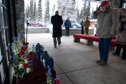 A U.S. Army veteran renders a salute to the remains of five veterans after an unaccompanied funeral service at the Fort Richardson National Cemetery on Joint Base Elmendorf-Richardson, Alaska, Nov. 30, 2022. The Department of Military and Veterans Affairs works jointly with the federally recognized non-profit organization Missing in American Project in locating, identifying and interring the unclaimed cremated remains of veterans with full honors and ceremony. (Alaska National Guard photo by Victoria Granado)