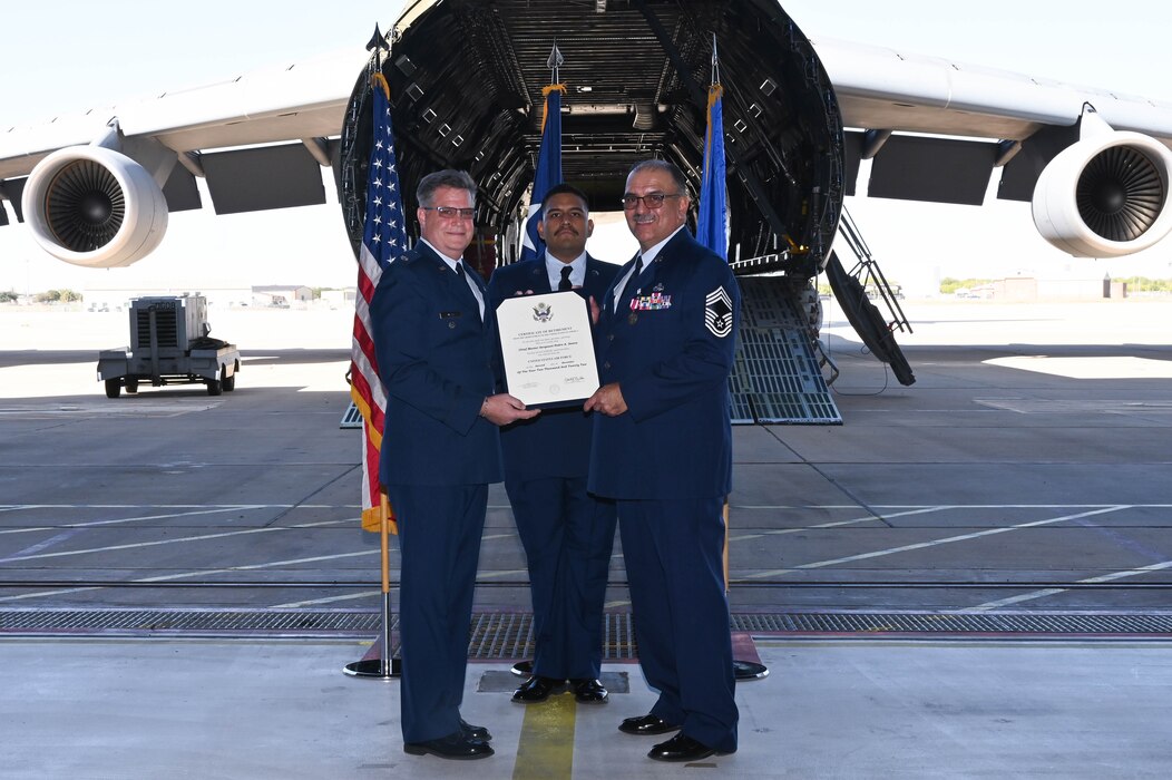 Lt. Col. Michael Webb, former 433rd Aircraft Maintenance Squadron commander, presents a certificate of retirement to Chief Master Sgt. Pedro Saenz, 433rd AMXS superintendent, during a ceremony at hangar 826 on Joint Base San Antonio-Lackland, Texas, Nov. 5, 2022. Saenz began his Air Force career in 1987 as a hydraulics mechanic working on the F-111D Aardvark combat aircraft at Cannon Air Force Base, New Mexico. He retired with over 35 years of military service. (U.S. Air Force photo by Senior Airman Brittany Wich)