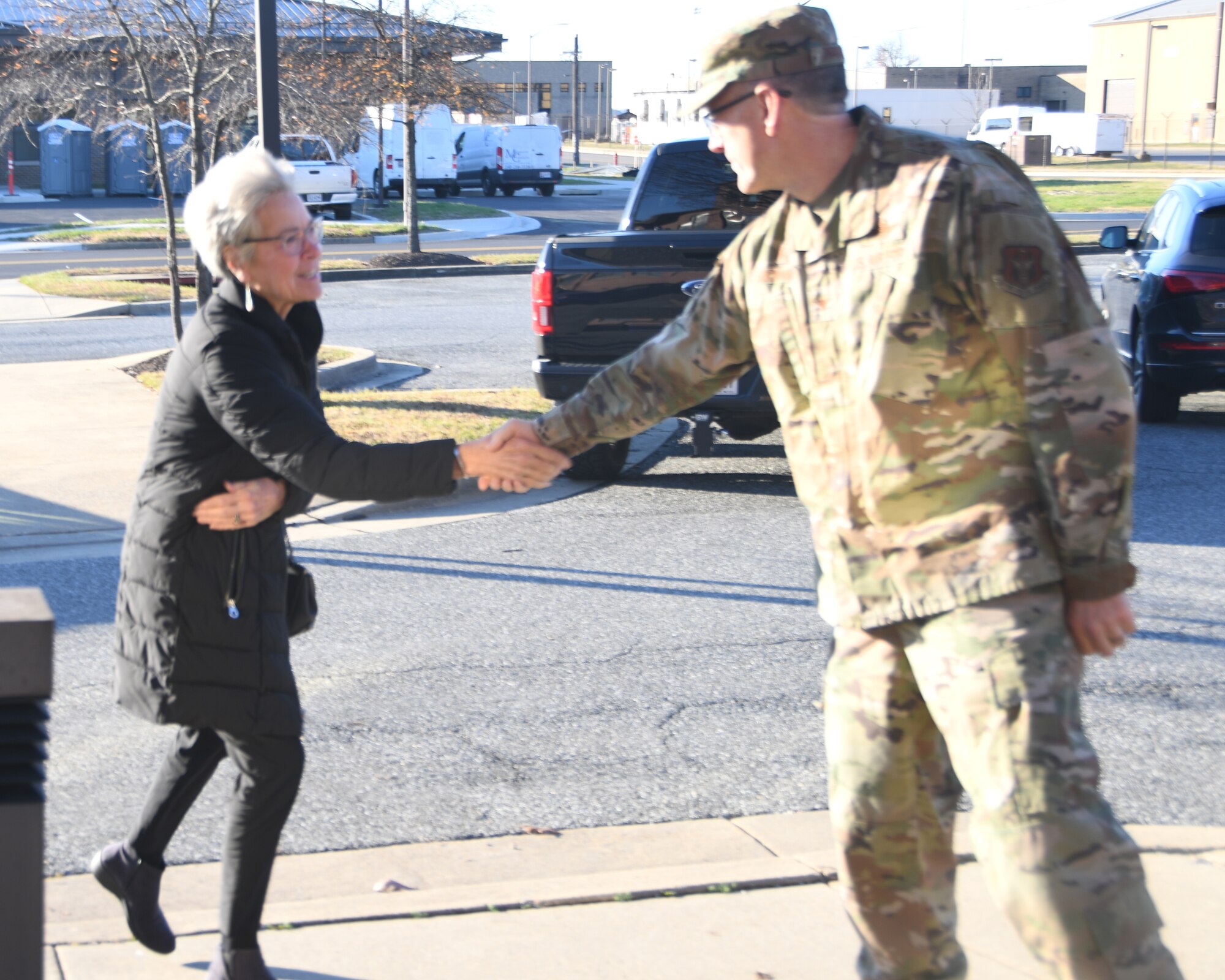 Col. Greg Buchanan, 459th Air Refueling Wing Commander, greets Defense Health Board president, Karen Guice, M.D., upon arrival for the board’s visit to the 459th ARW on Dec. 1, 2022. The DHB requested a visit to Joint Base Andrews for an opportunity to see the pivotal role medical units at Joint Base Andrews play in the global patient movement pipeline and the challenges faced in supporting this critical effort. (U.S. Air Force Photo by Maj. Tim Smith)