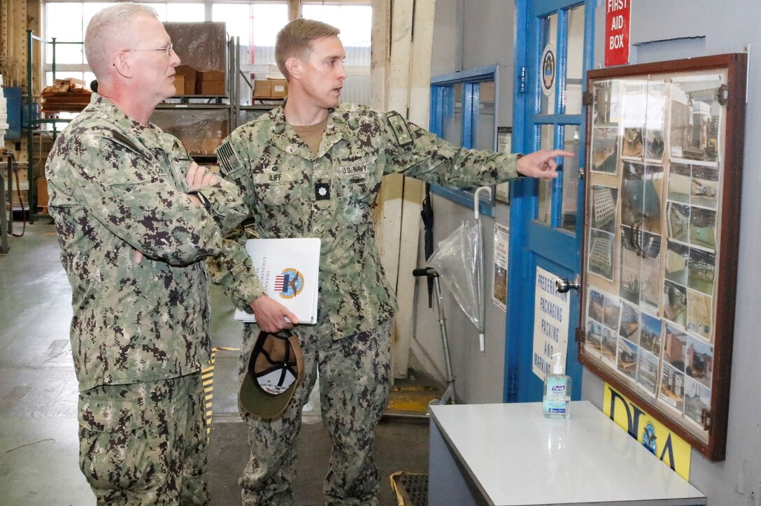 Two military men review progress reports.