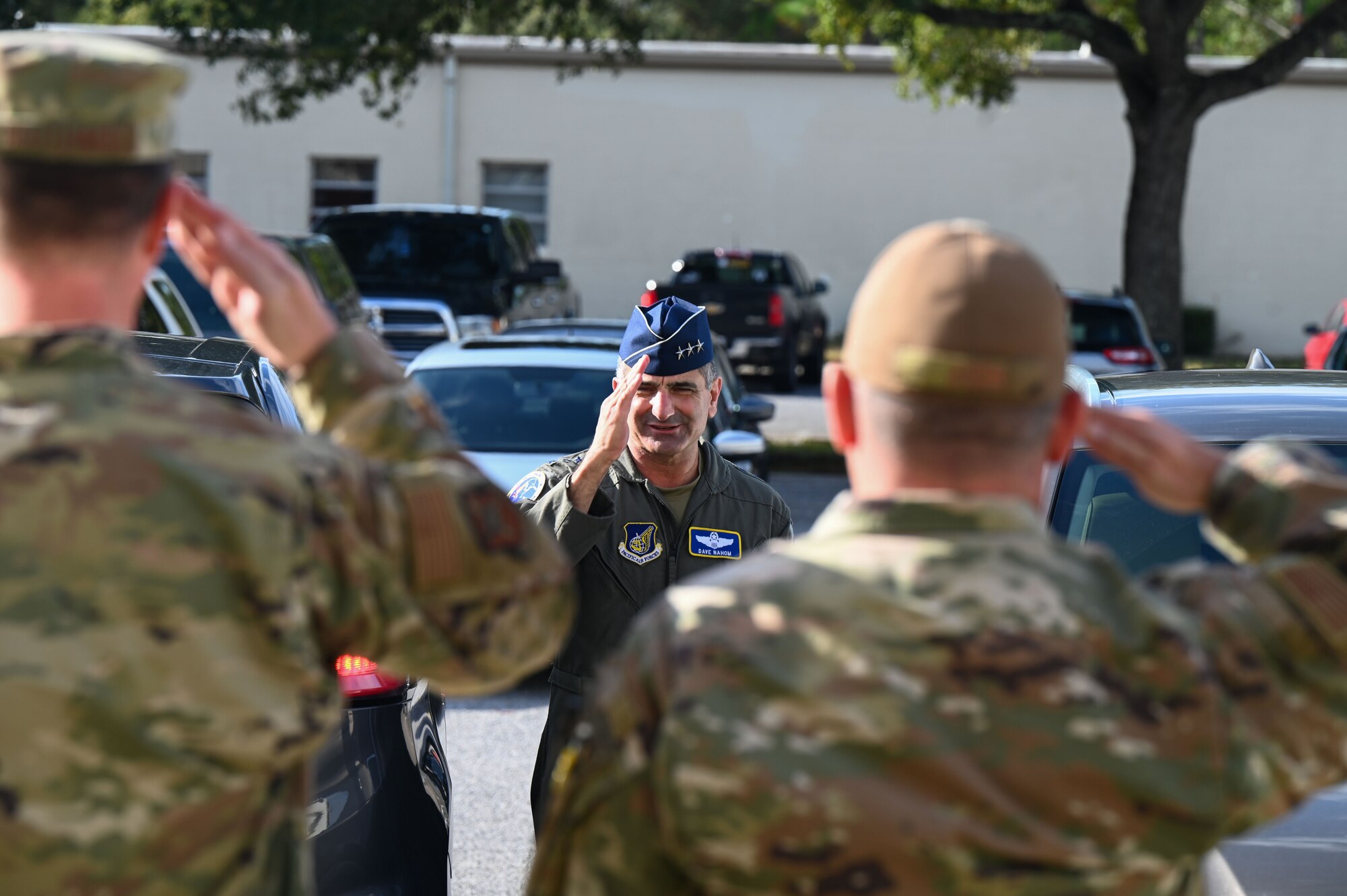 U.S. Air Force Lt. Gen. David S. Nahom, commander of Alaskan NORAD Region, Alaskan Command and Eleventh Air Force, salutes the 350th Spectrum Warfare Wing leadership during his visit at Eglin Air Force Base, Fla., Nov. 28, 2022. The 350th SWW will develop and employ evolutionary, cutting-edge capabilities to air component commanders. (U.S. Air Force photo by 1st Lt. Benjamin Aronson)