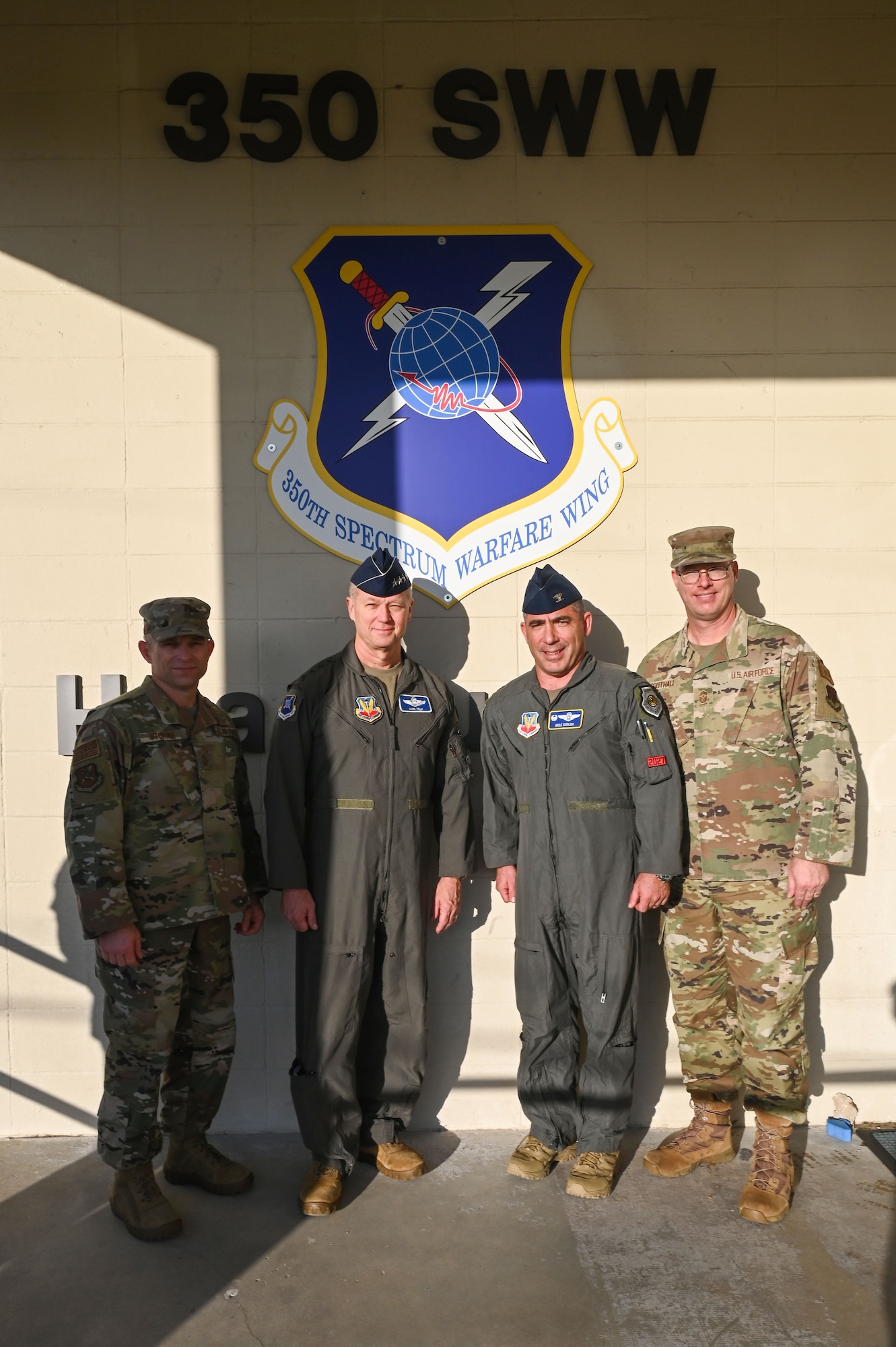 U.S. Air Force Command Chief Master Sgt. John Storms, Air Combat Command, left Gen. Mark Kelly, commander of Air Combat Command, left center, Col. Josh Koslov, 350th Spectrum Warfare Wing commander, right center, and Chief Master Sgt. David Southall, 350th SWW command chief, right, pose for a photo at Eglin Air Force Base, Fla., Nov. 30, 2022. The 350th SWW serves as the Air Force’s first EMS focused wing on enhancing air component commanders’ ability to synchronize, integrate and execute EMS capabilities across all domains and platforms. (U.S. Air Force photo by Staff Sgt. Ericka A. Woolever)