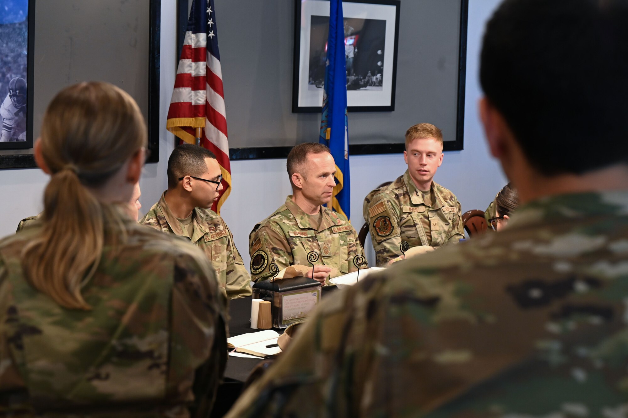 U.S. Air Force Command Chief Master Sgt. John Storms, Air Combat Command, center, sits down with 350th Spectrum Warfare Wing members to answer questions at Eglin Air Force Base, Fla., Nov. 30, 2022. The 350th SWW focuses on developing multi-capable adaptive team builders, and courageous problem solvers, who demonstrate value in diversity of thought, ingenuity, and initiative. (U.S. Air Force photo by 1st Lt. Benjamin Aronson)