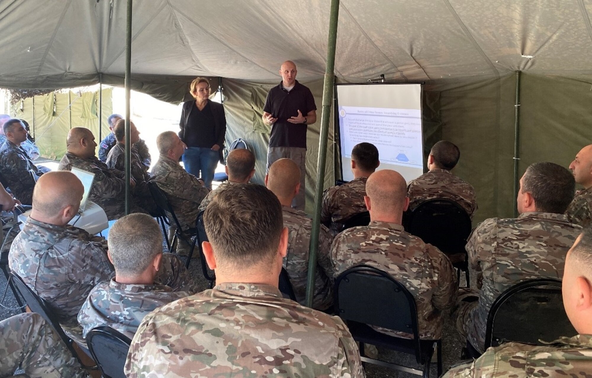 OSI Forensic Science Consultant Michael Buckley, 
4th Field Investigations Squadron Vogelweh Cantonment, Germany, explains Locard’s exchange principle’s connection to evidence collection to Georgian Military Police. (Photo courtesy SA Mark Ryan, FPD Tbilisi, Georgia)