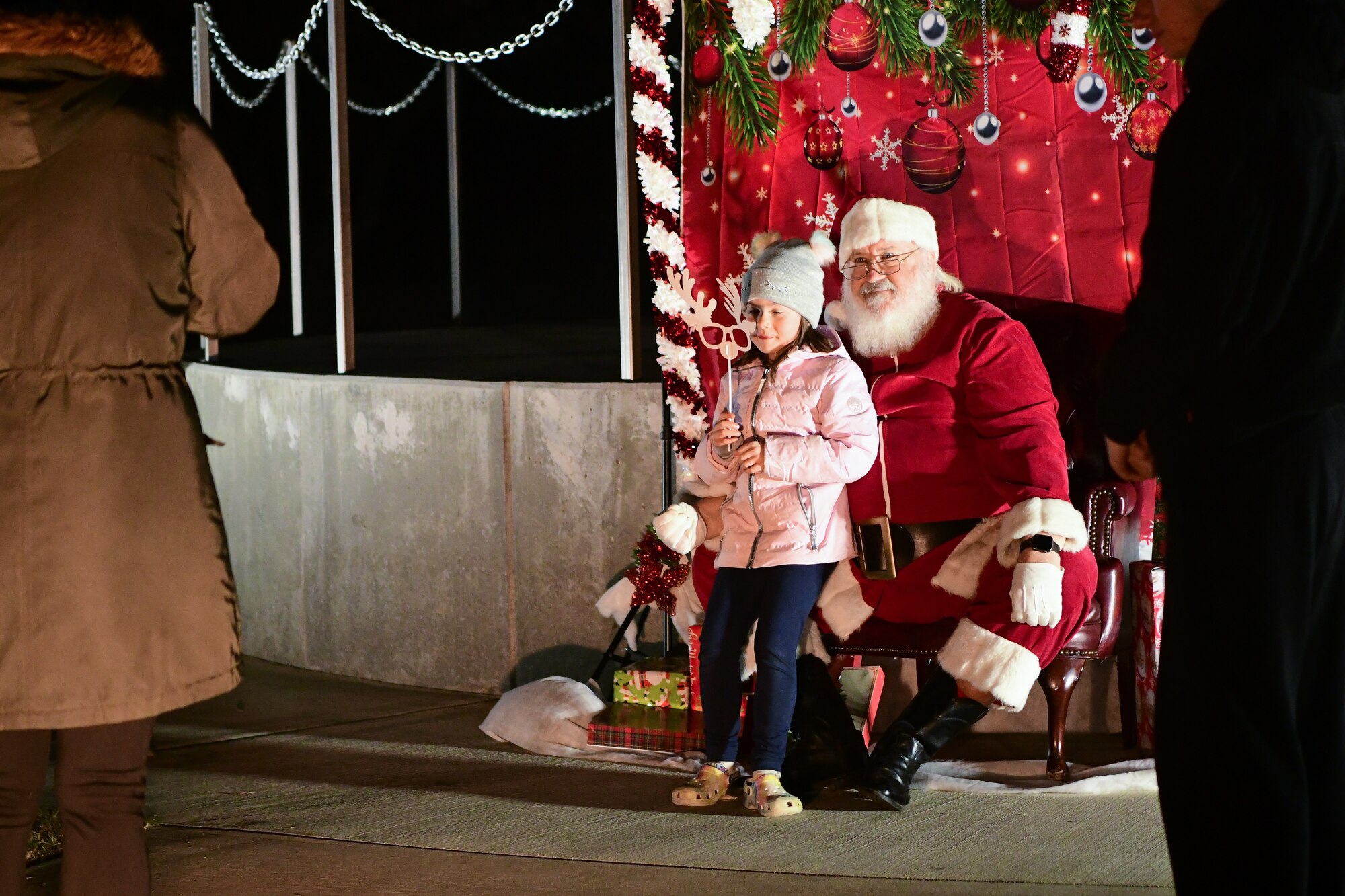 A child takes a photo with Santa at the Christmas tree lighting ceremony on Beale Air Force Base, Calif. on Dec. 2, 2022.