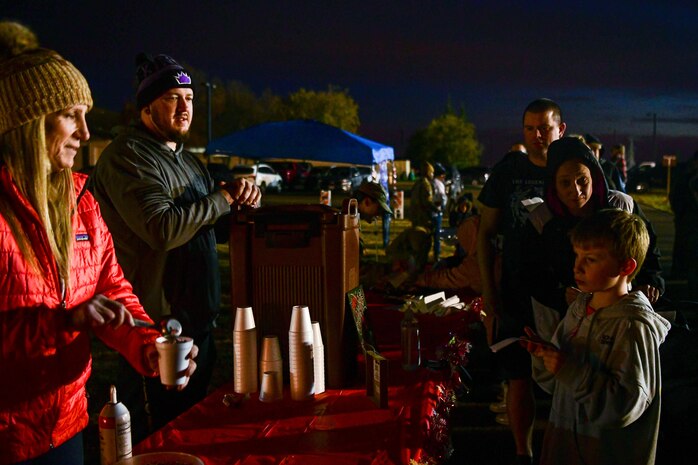 Hot chocolate is passed out by volunteers during the Christmas tree lighting ceremony on Beale Air Force Base, Calif. on Dec. 2, 2022