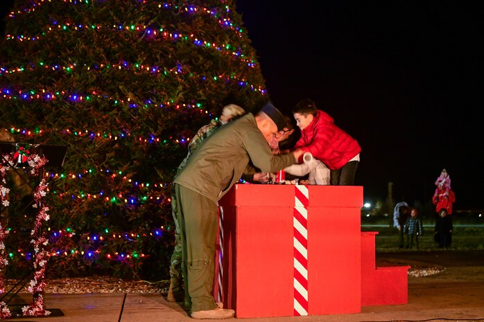 Col. Geoffrey Church, 9th Reconnaissance Wing commander, and Command Chief Master Sgt Breana Oliver, 9th Reconnaissance Wing command chief, and the Gamboa family light the tree during the Christmas tree lighting ceremony at Beale Air Force Base, Calif., on Dec. 2, 2022.