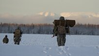 University of Alaska Army ROTC cadets move across the Malemute drop zone after unloading from an Alaska Army National Guard UH-60L Black Hawk helicopter assigned to 1-207th Aviation Regiment during an air assault training event at Joint Base Elmendorf-Richardson, Alaska, Dec. 2. The Seawolf ROTC Detachment continued maneuvering across more than one mile of frozen terrain to assault opposition forces and secure its objective. The Alaska Army National Guard’s General Support Aviation Battalion routinely trains with all branches of the military as well as civilian agencies to increase its operational interoperability and to be ready for a wide range of federal and state missions.