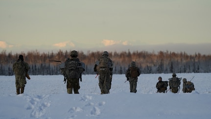 University of Alaska Army ROTC cadets move across the Malemute drop zone after unloading from an Alaska Army National Guard UH-60L Black Hawk helicopter assigned to 1-207th Aviation Regiment during an air assault training event at Joint Base Elmendorf-Richardson, Alaska, Dec. 2. The Seawolf ROTC Detachment continued maneuvering across more than one mile of frozen terrain to assault opposition forces and secure its objective. The Alaska Army National Guard’s General Support Aviation Battalion routinely trains with all branches of the military as well as civilian agencies to increase its operational interoperability and to be ready for a wide range of federal and state missions.