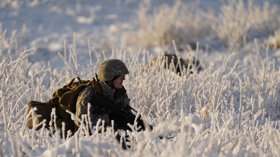 A University of Alaska Army ROTC cadet takes up a defensive position after unloading from an Alaska Army National Guard UH-60L Black Hawk helicopter assigned to 1-207th Aviation Regiment during an air assault training event at Joint Base Elmendorf-Richardson, Alaska, Dec. 2. The Seawolf ROTC Detachment maneuvered across more than one mile of frozen terrain to assault opposition forces and secure its objective. The Alaska Army National Guard’s General Support Aviation Battalion routinely trains with all branches of the military as well as civilian agencies to increase its operational interoperability and to be ready for a wide range of federal and state missions.