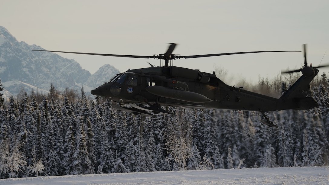 An Alaska Army National Guard UH-60L Black Hawk helicopter assigned to 1-207th Aviation Regiment makes a tactical approach into Malemute drop zone on Joint Base Elmendorf-Richardson, Alaska, Dec. 2. The air crew conducted air assault training with the University of Alaska ROTC detachment during its end-of-semester training exercise. The Alaska Army National Guard’s General Support Aviation Battalion routinely trains with all branches of the military as well as civilian agencies to increase its operational interoperability and to be ready for a wide range of federal and state missions.