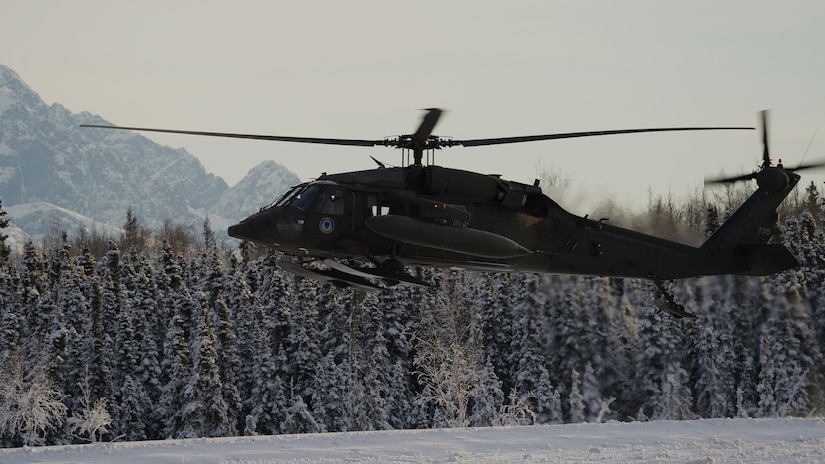 An Alaska Army National Guard UH-60L Black Hawk helicopter assigned to 1-207th Aviation Regiment makes a tactical approach into Malemute drop zone on Joint Base Elmendorf-Richardson, Alaska, Dec. 2. The air crew conducted air assault training with the University of Alaska ROTC detachment during its end-of-semester training exercise. The Alaska Army National Guard’s General Support Aviation Battalion routinely trains with all branches of the military as well as civilian agencies to increase its operational interoperability and to be ready for a wide range of federal and state missions.