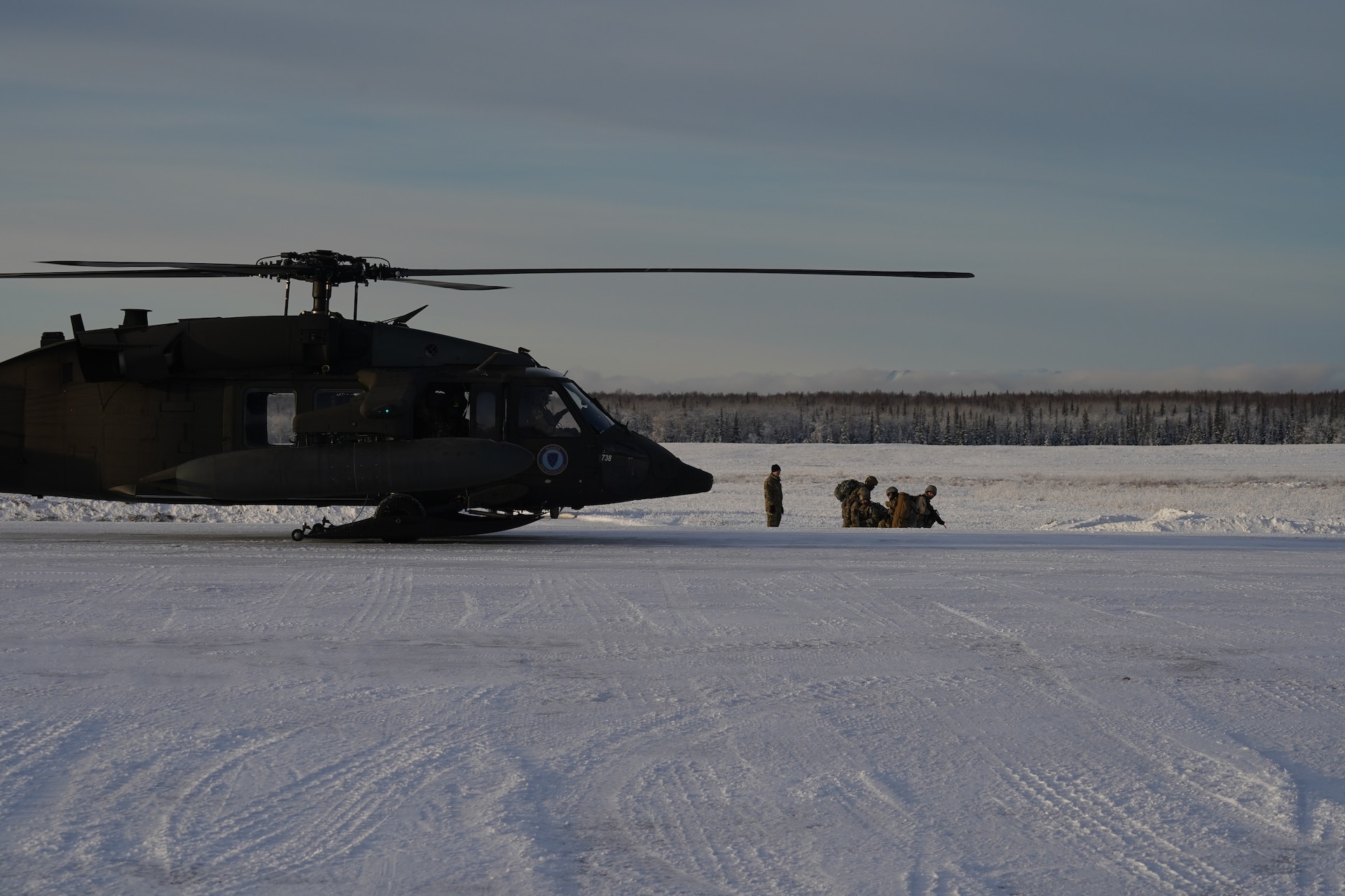 University of Alaska Army ROTC cadets’ stage at the designated landing zone on the Malemute drop zone on Joint Base Elmendorf-Richardson Alaska, Dec. 2, as an Alaska Army National Guard UH-60L Black Hawk helicopter assigned to 1-207th Aviation Regiment approaches to conduct an extraction. The Seawolf ROTC Detachment maneuvered across more than one mile of frozen terrain to assault opposition forces and secure its objective. The Alaska Army National Guard’s General Support Aviation Battalion routinely trains with all branches of the military as well as civilian agencies to increase its operational interoperability and to be ready for a wide range of federal and state missions.