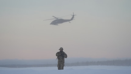 Alaska Army National Guard Capt. Danny Canlas, University of Alaska- Anchorage assistant professor of Military Science, observes the cadets from the Seawolf ROTC Detachment as an Alaska Army National Guard UH-60L Black Hawk helicopter assigned to 1-207th Aviation Regiment departs the Malemute drop zone on Joint Base Elmendorf-Richardson. The Seawolf Detachment conducted air assault operations as part of its end-of-semester training exercise. The Alaska Army National Guard’s General Support Aviation Battalion routinely trains with all branches of the military as well as civilian agencies to increase its operational interoperability and to be ready for a wide range of federal and state missions.