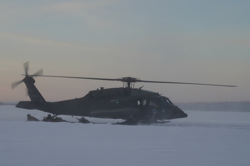 An Alaska Army National Guard UH-60L Black Hawk helicopter assigned to 1-207th Aviation Regiment delivers a squad of University of Alaska Army ROTC Cadets to their designated landing zone at Joint Base Elmendorf-Richardson, Alaska, Dec. 2. The Seawolf ROTC Detachment continued maneuvering across more than one mile of frozen terrain to assault opposition forces and secure its objective. The Alaska Army National Guard’s General Support Aviation Battalion routinely trains with all branches of the military as well as civilian agencies to increase its operational interoperability and to be ready for a wide range of federal and state missions.
