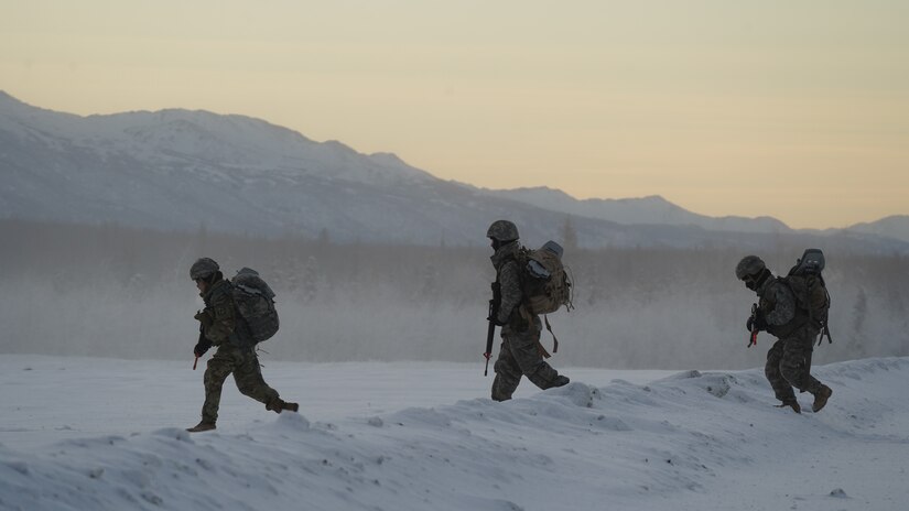 University of Alaska Army ROTC cadets move across the Malemute drop zone after unloading from an Alaska Army National Guard UH-60L Black Hawk helicopter, assigned to 1-207th Aviation Regiment, during an air assault training event at Joint Base Elmendorf-Richardson, Alaska, Dec. 2. The Seawolf ROTC Detachment continued maneuvering across more than one mile of frozen terrain to assault opposition forces and secure its objective. The Alaska Army National Guard’s General Support Aviation Battalion routinely trains with all branches of the military as well as civilian agencies to increase its operational interoperability and to be ready for a wide range of federal and state missions.