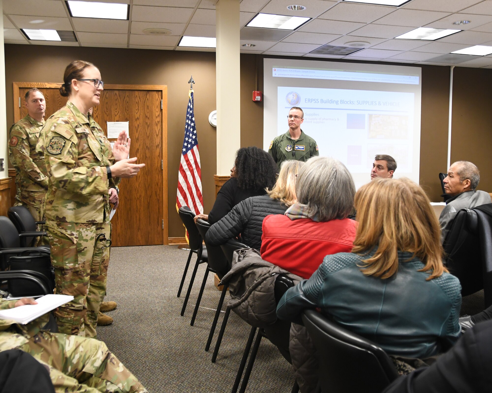 Lt. Col. Jennifer Cowie, 459th Aeromedical Evacuation Squadron Commander, talks to Defense Health Board members during their visit to the 459th ARW on Dec. 1, 2022. The DHB requested a visit to Joint Base Andrews for an opportunity to see the pivotal role medical units at Joint Base Andrews play in the global patient movement pipeline and the challenges faced in supporting this critical effort. (U.S. Air Force Photo by Maj. Tim Smith)