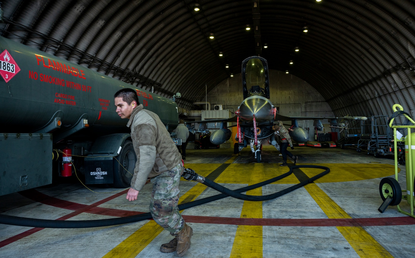 U.S. Air Force Airman 1st Class Christopher Munoz, 51st Logistics Readiness Squadron (LRS) fuels equipment maintenance technician pulls a fuel hose after refueling an F-16 Fighting Falcon at Osan Air Base, Republic of Korea, Dec. 1, 2022.