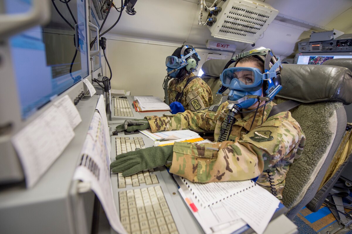 U.S. Air Force Capt. Colleen Wildermuth, right, a senior director with the 12th Airborne Command and Control Squadron, and Army Chief Warrant Officer 2 Adrienne Coleman, a deputy mission crew commander with Army JSTARS, participate in an emergency drill onboard an E-8C Joint STARS during a routine training mission at Robins Air Force Base, Ga., March 21, 2019.  Team JSTARS is a joint manned, airborne command and control, intelligence, surveillance, reconnaissance and combat support force providing information to combatant commanders world-wide. (U.S. Air National Guard photo by Tech. Sgt. Nancy Goldberger) (This photo has been blurred for security)