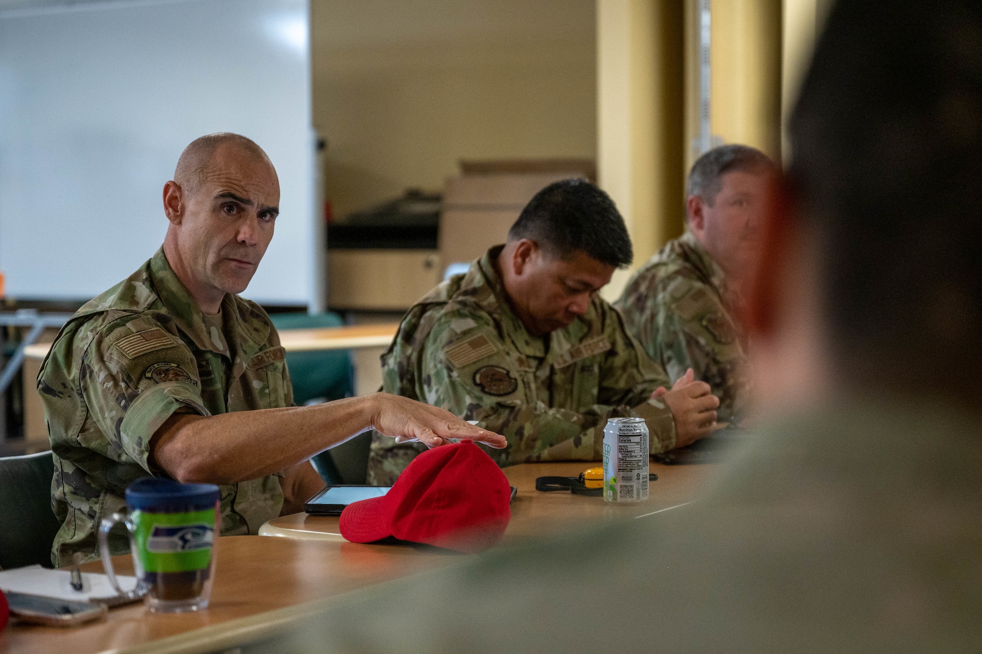 U.S. Air Force Col. Adam Roberts, the 555 RED HORSE Squadron commander, engages in discussion during a staff meeting at Nellis Air Force base, Nevada, September 20, 2022. Roberts regularly touches base with higher enlisted and officer personnel in order to tackle any issues that may arise. (U.S. Air Force photo by Staff Sgt. Timothy Leddick) (this photo has been edited to enhance the subject)