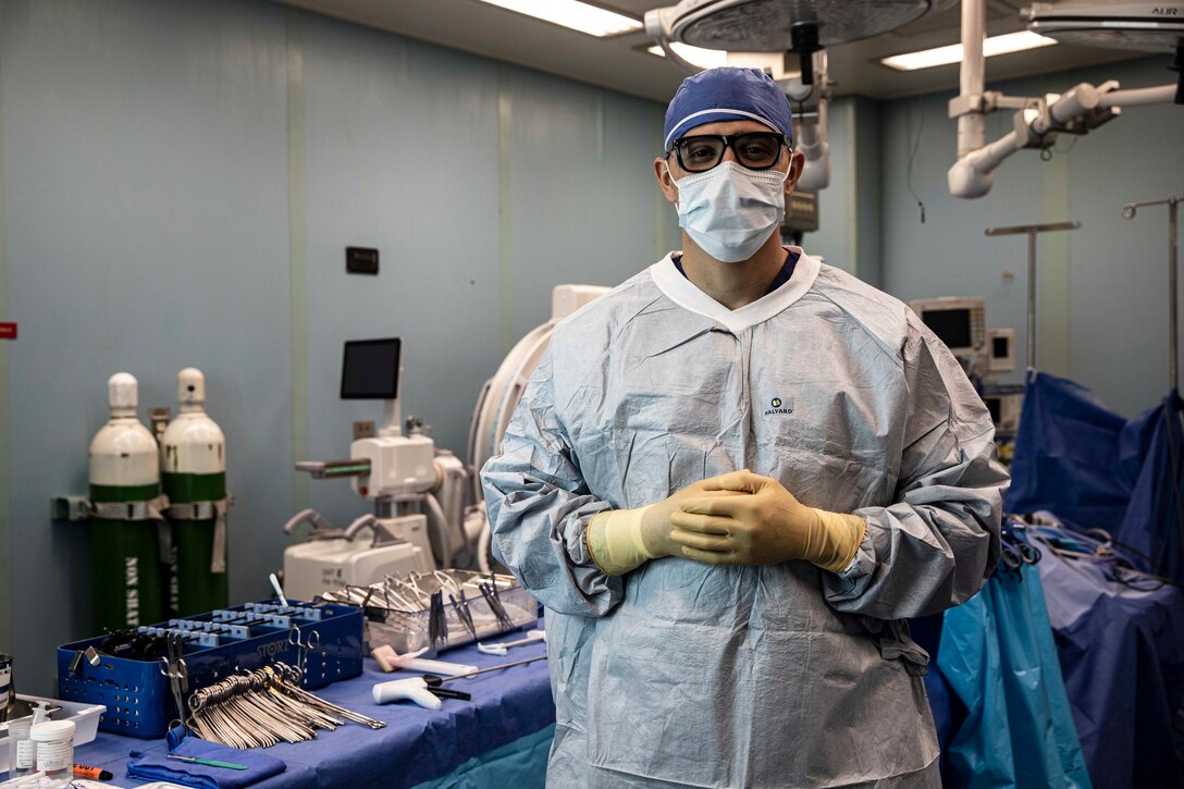 221117-N-VQ841-2001 CARTAGENA, Colombia (Nov. 17, 2022) - Hospital Corpsman 2nd Class Bryam Pulgarin, from Medellín, Colombia, a surgical technician assigned to hospital ship USNS Comfort (T-AH 20), poses for a photograph in an operating room aboard Comfort, Nov. 17 2022. Comfort is deployed to U.S. 4th Fleet in support of Continuing Promise 2022, a humanitarian assistance and goodwill mission conducting direct medical care, expeditionary veterinary care, and subject matter expert exchanges with five partner nations in the Caribbean, Central and South America. (U.S. Navy photo by Mass Communication Specialist 2nd Class Ethan J. Soto)