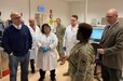 Army Col. Crystal Hills, the commander of the 405th Army Field Support Brigade, addresses employees at the 405th AFSB’s Army Oil Analysis Program Laboratory Europe at the Kaiserslautern Army Depot, Dec. 5. The mission of the 405th AFSB’s AOAP lab is to provide and execute AOAP for U.S. European Command and U.S. Africa Command by supporting warfighters with the most technological advanced diagnostic tools capable of worldwide mobilization for detecting impending failures in oil wetted components before catastrophic failures occur. (Photo by Sgt. 1st Class Guido Fermin)
