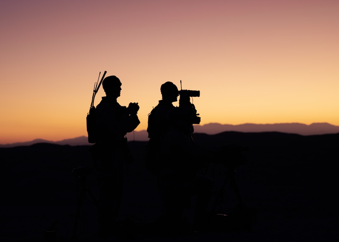 U.S. Marines with 1st Battalion, 11th Marine Regiment, and 1st Battalion, 1st Marine Regiment, 1st Marine Division, observe impact zones during a fire support coordination exercise as part of Steel Knight 23 at Marine Corps Air Ground Combat Center Twentynine Palms, California, Nov. 30, 2022. Steel Knight is an annual combined arms live-fire exercise which ensures 1st MARDIV is optimized for naval expeditionary warfare in contested spaces, and is purpose-built to facilitate future operations afloat and ashore. (U.S. Marine Corps photo by Lance Cpl. Barton)