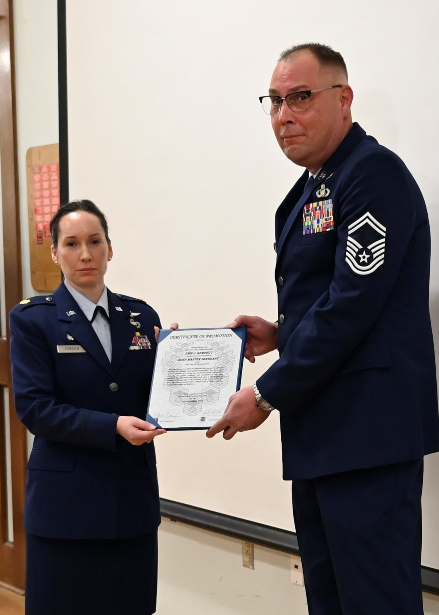 U.S. Air Force Senior Master Sgt. John Kempisty, 174th Communications Squadron, Hancock Air National Guard base, was promoted to the rank of Chief Master Sergeant by Maj. Melissa Forsyth, 174th Communications Squadron Commander on Dec 3, 2022. Kempisty has served in the Air National Guard for 34 years. (U.S. Air National Guard photo by Senior Airman Tiffany Scofield)