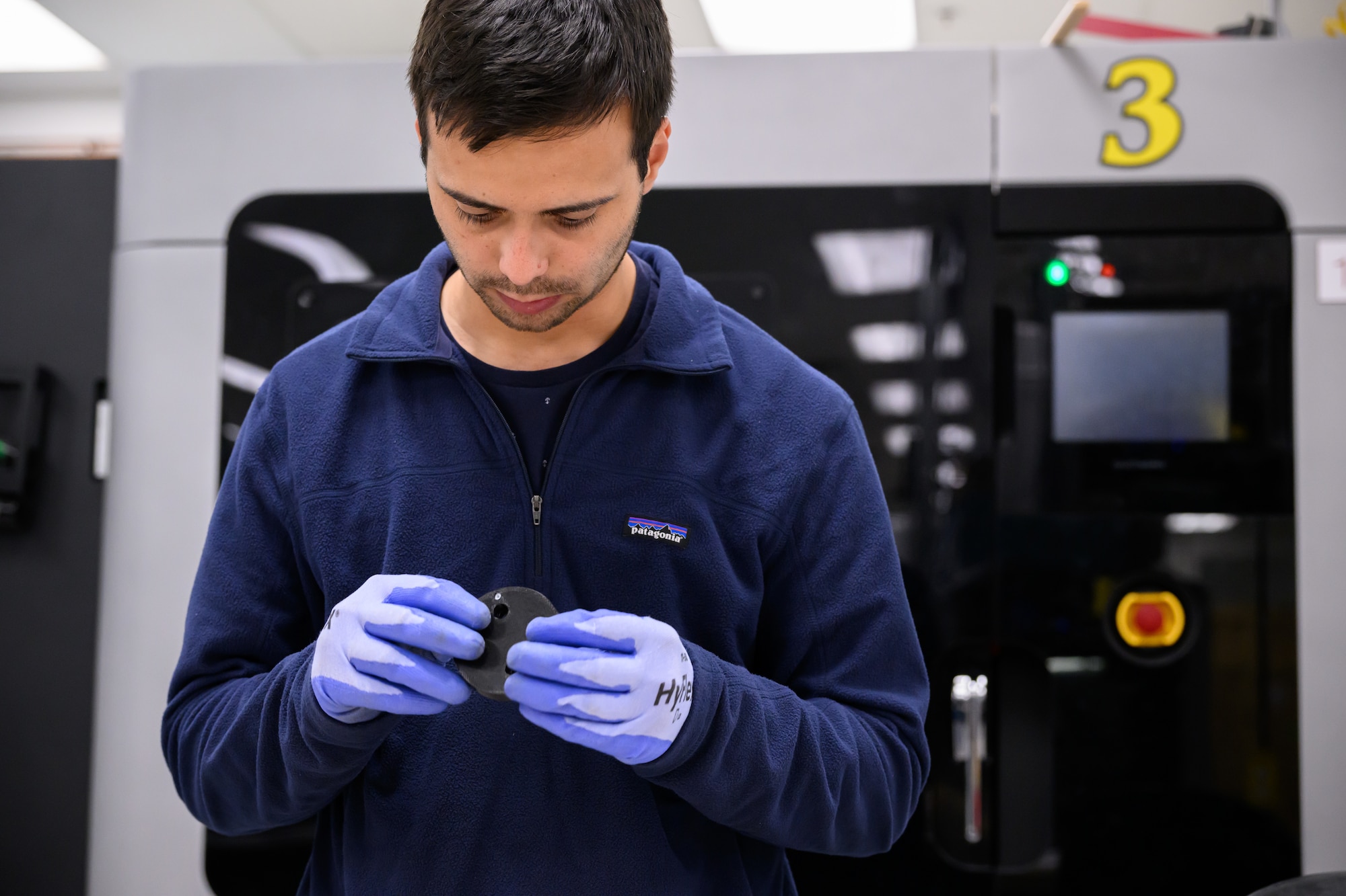 Ricardo Nicolia, 809th Maintenance Support Squadron mechanical engineer, inspects a 3D printed part at Hill Air Force Base, Utah, Dec. 2, 2022. (U.S. Air Force photo by R. Nial Bradshaw)