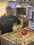 Chief Petty Officer Ava Stow cooks aboard the Coast Guard Cutter Dolphin, May 2019 (Photo courtesy of Chief Petty Officer Stow).