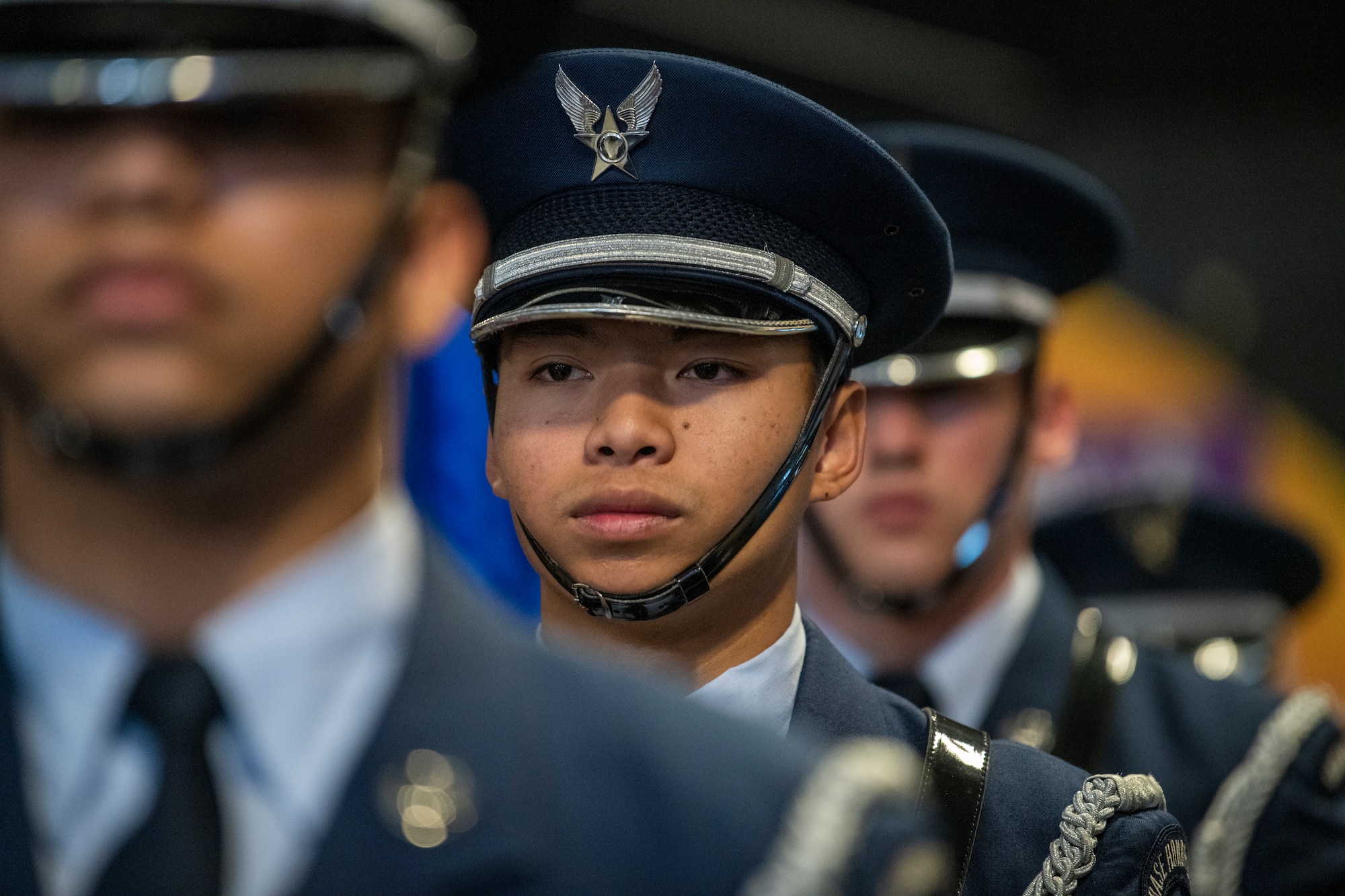 Airmen in military uniform stand in a line
