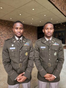 Soldier in uniform standing with twin brother.