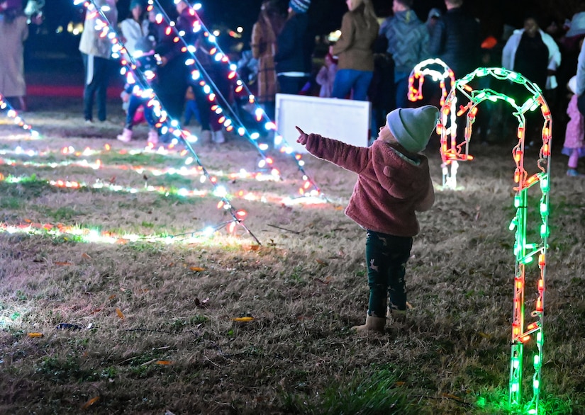 A child looking at the holiday tree.