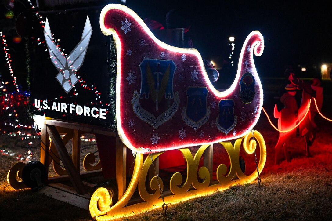 A holiday sleigh is decorated and lit.