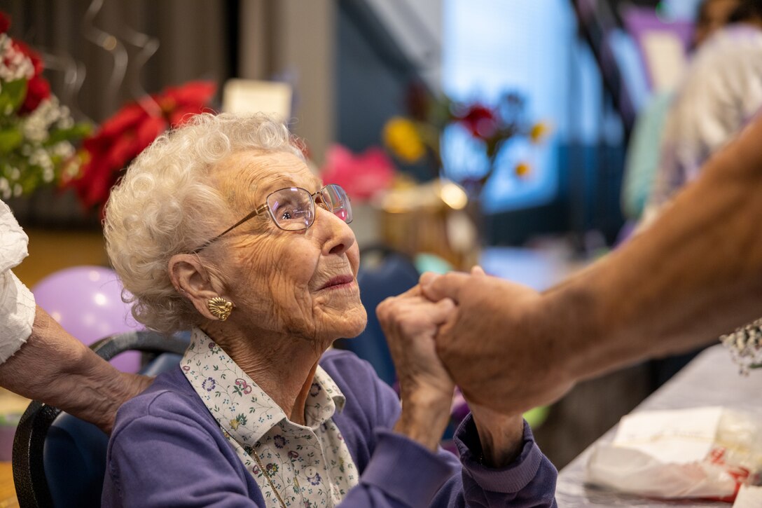 U.S. Marine Corps World War II veteran, Cpl. Dorothee Irwin, spends time with friends, family and service members at her 100th birthday party